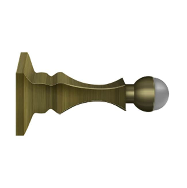 Deltana - 3-1/2'' Baseboard Door Bumper, HD, Solid Brass - Antique Brass